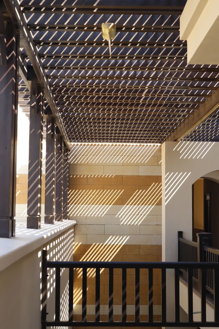 Modern architecture featuring striking light and shadow patterns indoors.